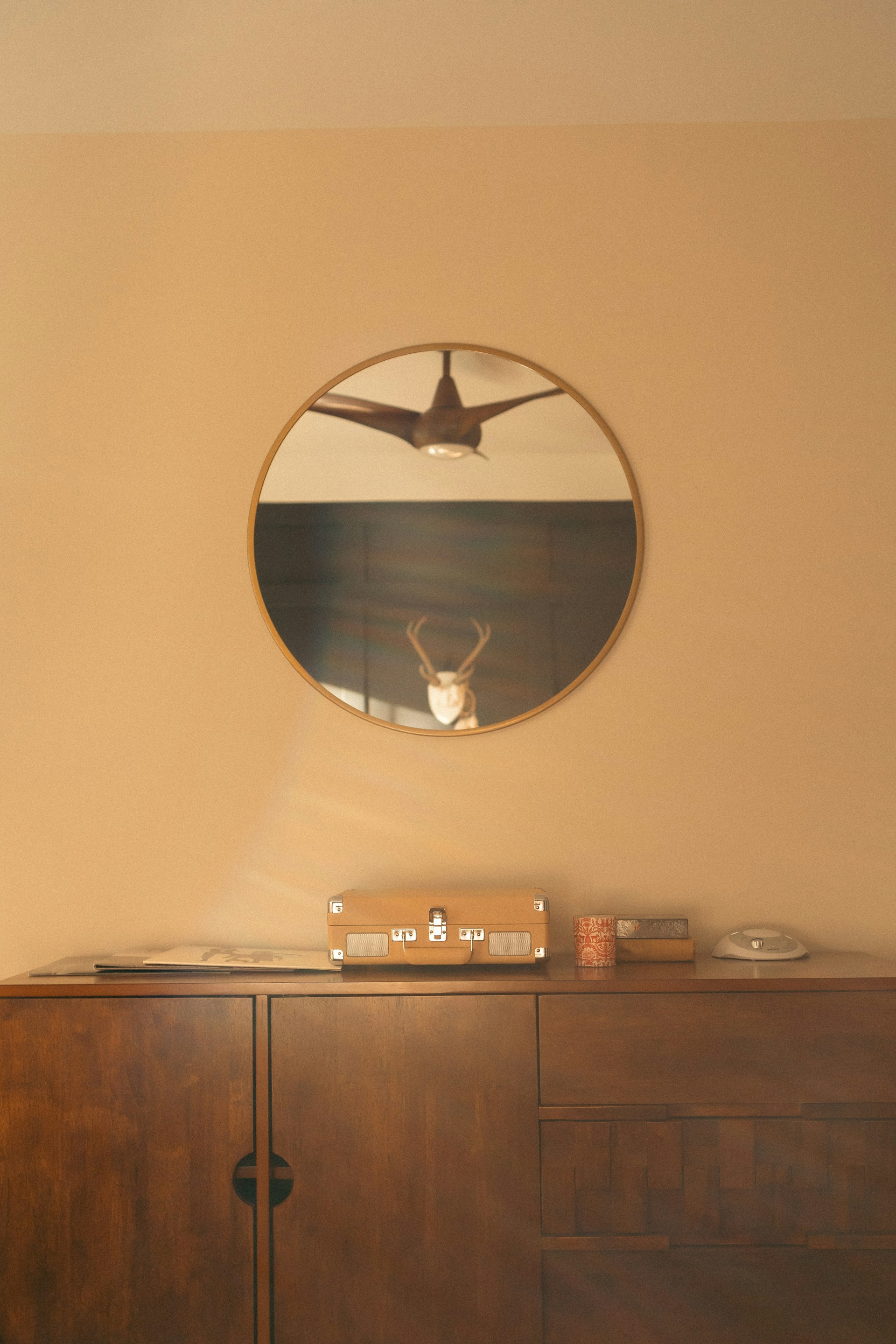 Stylish wooden cabinet with round mirror